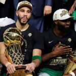 Boston Celtics forward Jayson Tatum (0) and guard Jaylen Brown (7) celebrates with the Larry O’Brien Trophy