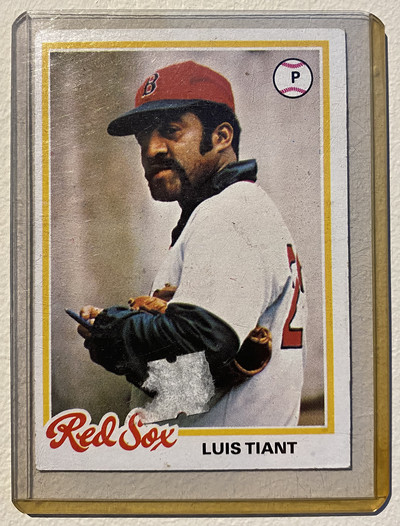 Luis Tiant’s 1978 baseball card features a photo of the player in uniform in a non-game situation, indicates he’s a pitcher, and displays his name and team: Luis Tiant, Red Sox.